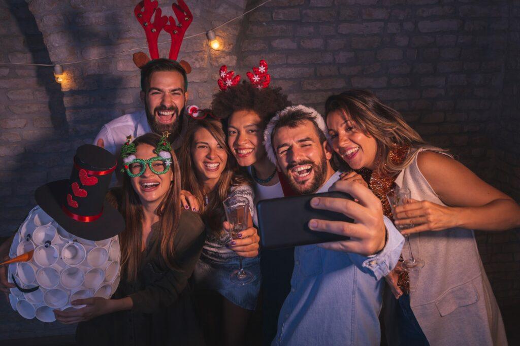 Friends taking selfies at New Year's Eve party